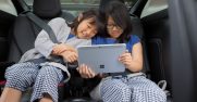 Two girls use Surface Go Lifestyle 1 in a car
