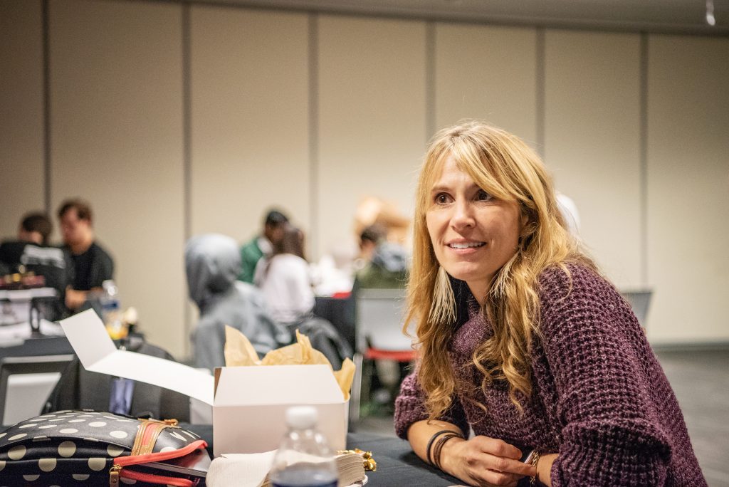 Photo of Noelle Foster, executive director of Unified Robotics, sitting at a table during a robot-building event on Microsoft's campus.