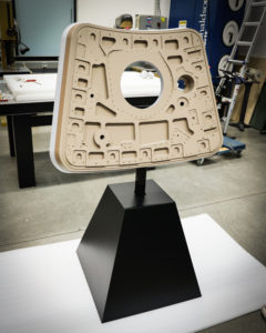 Apollo 11 hatch replica on a black display stand inside the APC lab