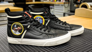 black high-top sneakers with Apollo 11 Eagle patch 