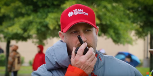 A member of Team Rubicon speaks on a walkie-talkie