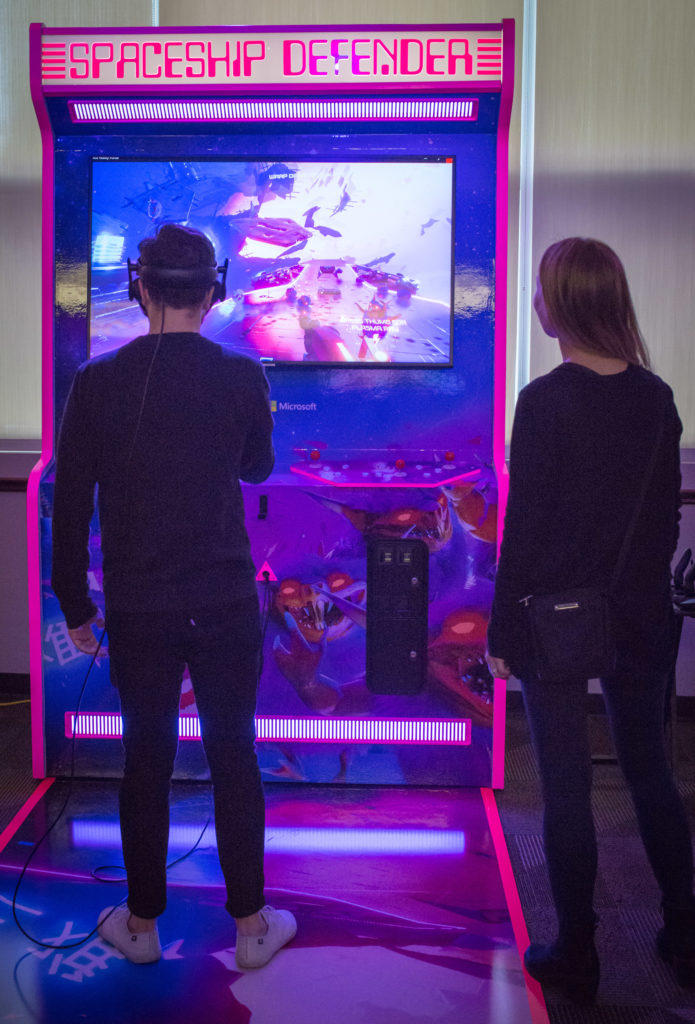 Photo of a young man playing one of the virtual reality games Microsoft developed for the band Muse during a pre-concert event in Houston, Texas on Feb. 22, 2019.
