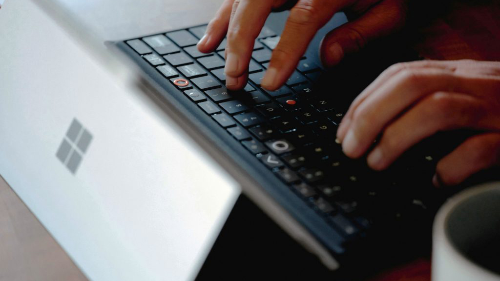 A person types on a keyboard