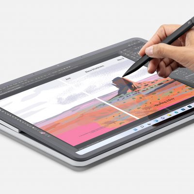 A person using a Surface pen on a Surface laptop