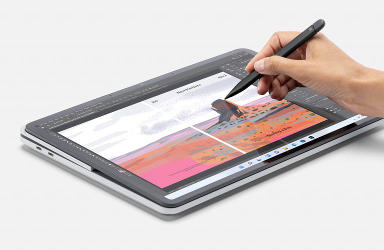 A person using a Surface pen on a Surface laptop