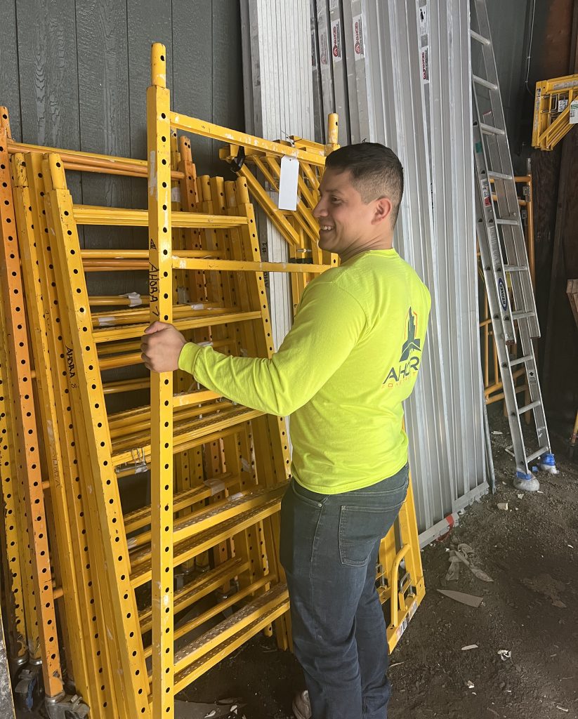 Man lifts a rack in a construction building