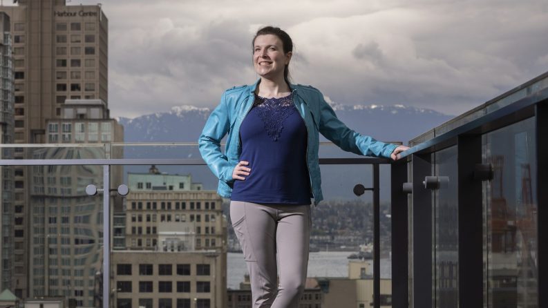 Katie Peters stands on a deck at TELUS’ headquarters in Vancouver, B.C.