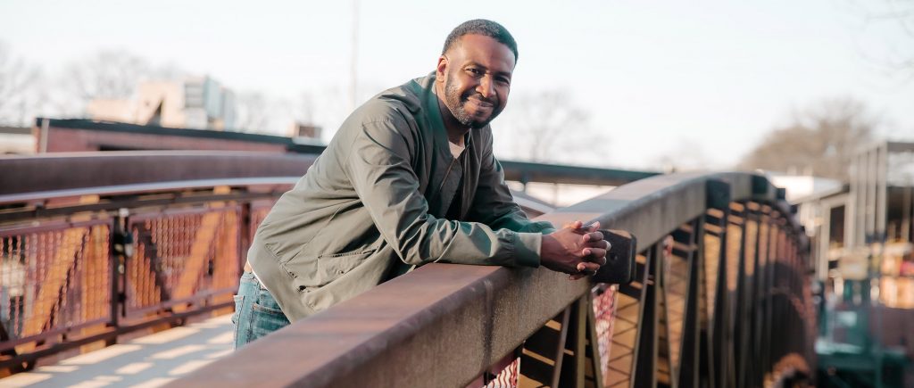 Man stands on bridge 