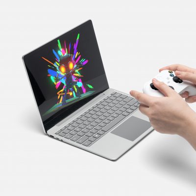 Person gaming on Surface Laptop Go 2 in Platinum