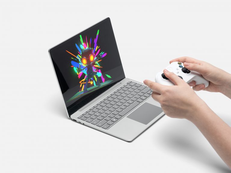 Person gaming on Surface Laptop Go 2 in Platinum
