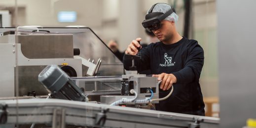 Man wearing HoloLens 2 adjusts machine