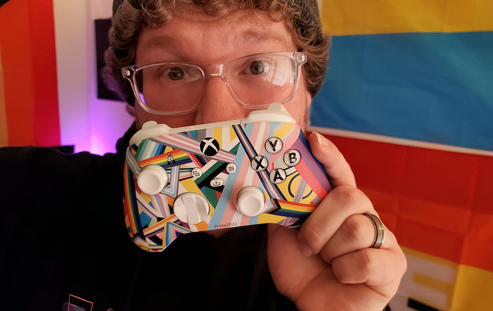 Man holds the Xbox Pride controller