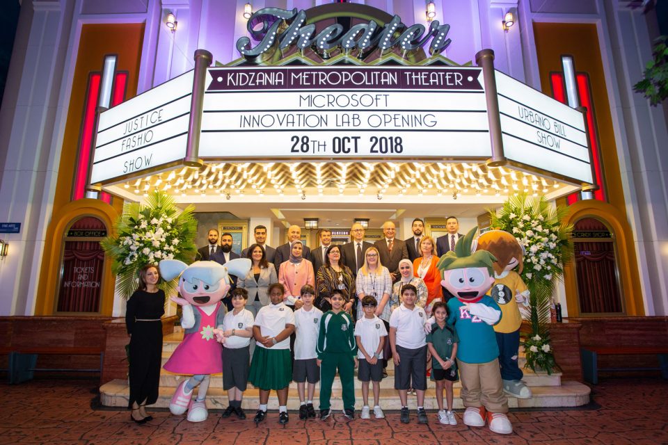 Group shot of kids with other company employees standing by KidZania Metropolitan Theater