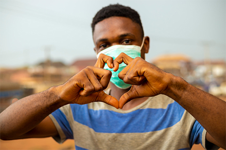 A young African man wearing a mask to protect himself from the Covid-19 pandemic.