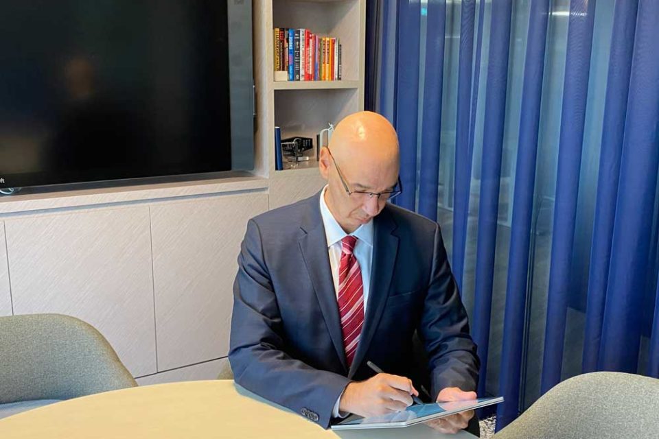 An individual signing a contract virtually
