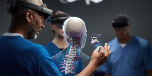 An experienced surgeon makes use of a mixed reality headset to interact with a virtual replica of the spinal column.