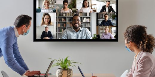 Two office workers in virtual conference with remote workers