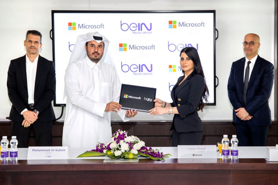 Microsoft and beIN representatives exchanging MoU document