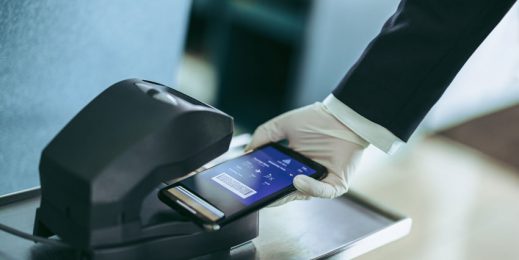 phone in hand that wears gloves scanning