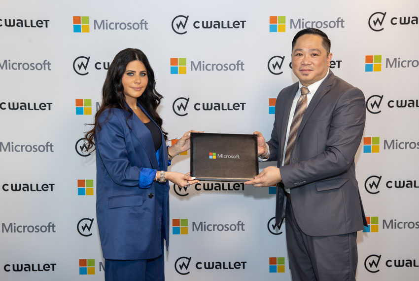 Lana Khalaf, General Manager of Microsoft Qatar and Michael Javier, CEO and Founder of CWallet exchanging MoU documents.