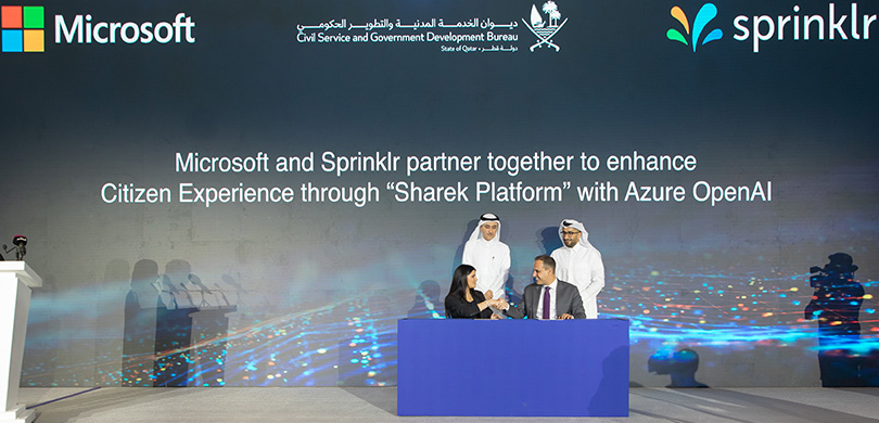 Lana Khalaf, General Manager, Microsoft Qatar, and Haitham Elkhatib, Senior Vice President of Growth Markets, Sprinklr singing the MoU, in the presence of Mr Hassan Abdulrahman Al Ibrahim, Director of Government Development Affairs, Civil Service and Government Development Bureau and Mr. Hassan Jassim Al Sayed, Advisor to the Minister and Chairman of the Artificial Intelligence Committee at the Ministry of Communications and Information Technology.