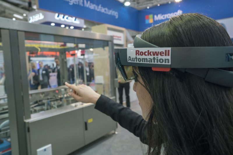 Fair participant uses HoloLens to interact with a Digital Twin at the Rockwell Automation demo.