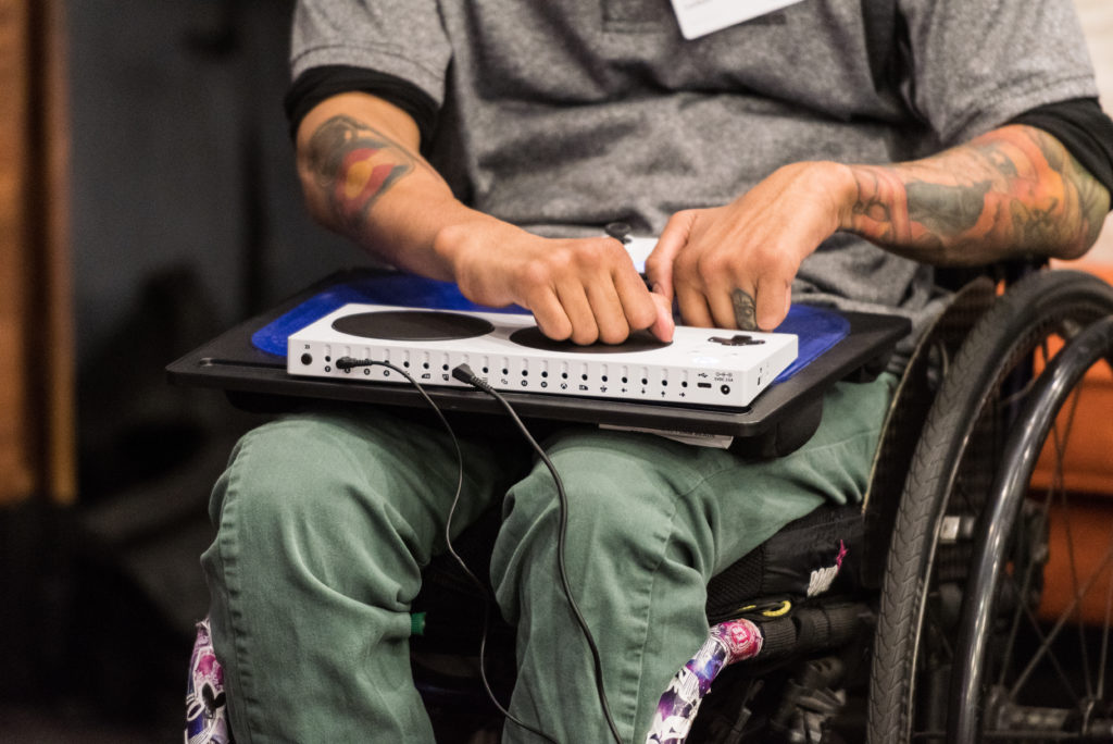 man in a wheelchair uses accessibility gaming device
