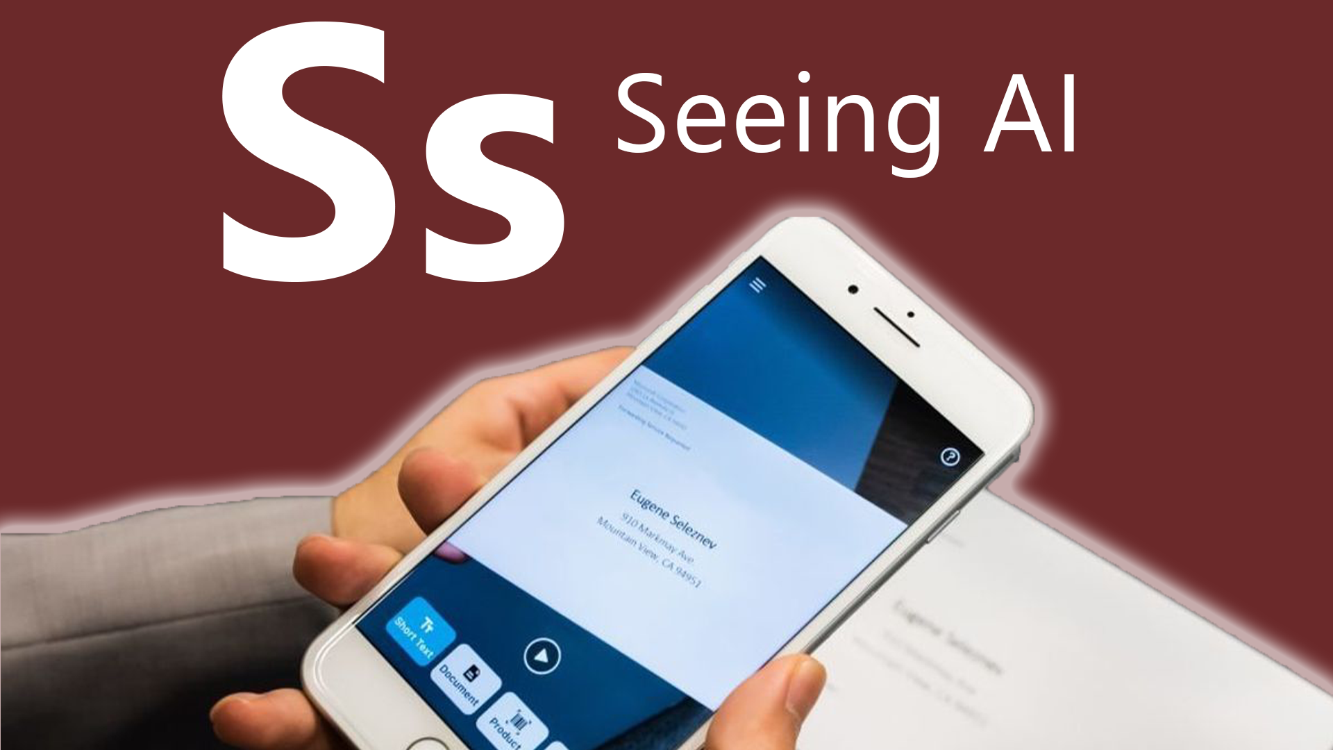 S is for Seeing AI. A person using the Seeing AI app to read a mailed letter.