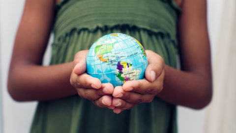 a globe being held by a young person