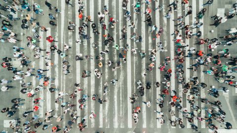 an abstract view of people crossing road from above