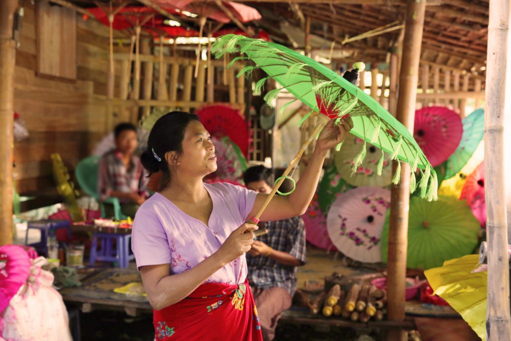 Thin Thin Kine examines one of the umbrellas made in her factory in Myanmar. She is among those worldwide who have benefitted from the growth of cloud-based banking in emerging and developing markets, where traditional banking services are not available.