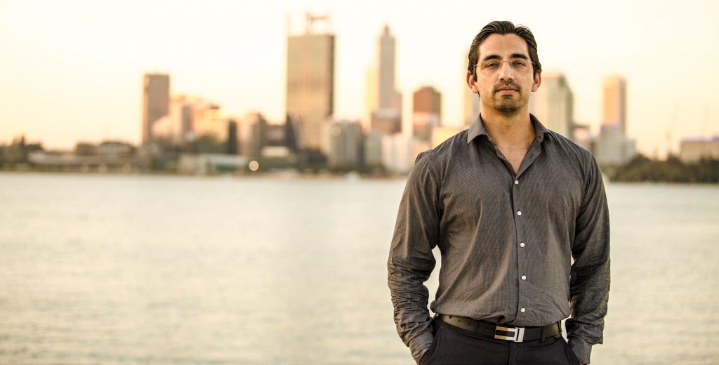 Photo of Kashif Saleem, founder and CEO of Track'em, with cityscape in background