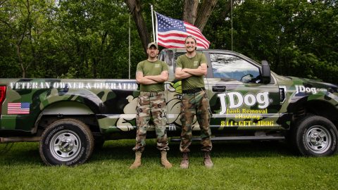 Andrew Weins and his brither Issac standing in front of a JDog pickup truck.