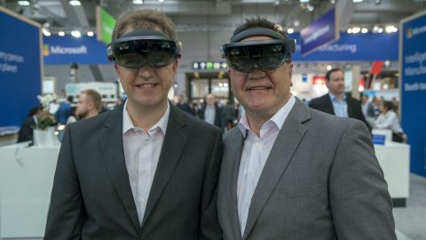 Ralf Krieger and Walter Bauch wear HoloLens at the Hannover Messe trade fair.