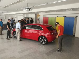 Employees attened a training session wearing HoloLens while looking at a Mercedes-Benz vehicle. .