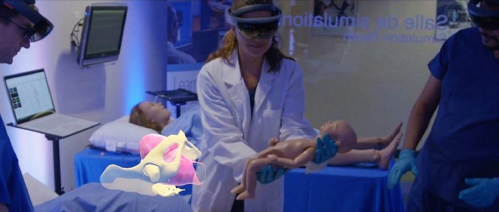 A medical student practices delivering a baby with the use of a virtual-to-live patient simulator and Hololens. 