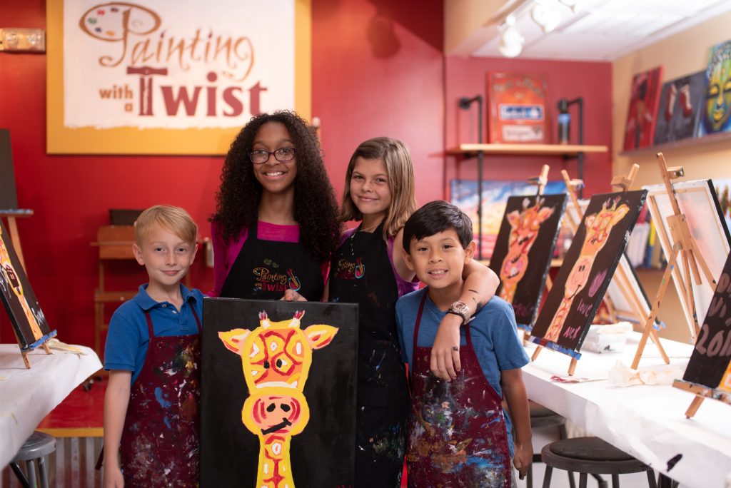 A photo of children holding a painting at Painting with a Twist.
