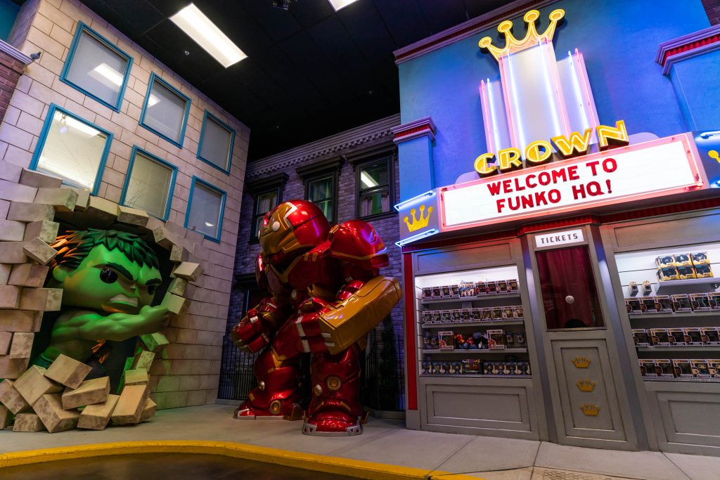 Two large toy characters are displayed next to a sign that says "Welcome to Funko HQ"