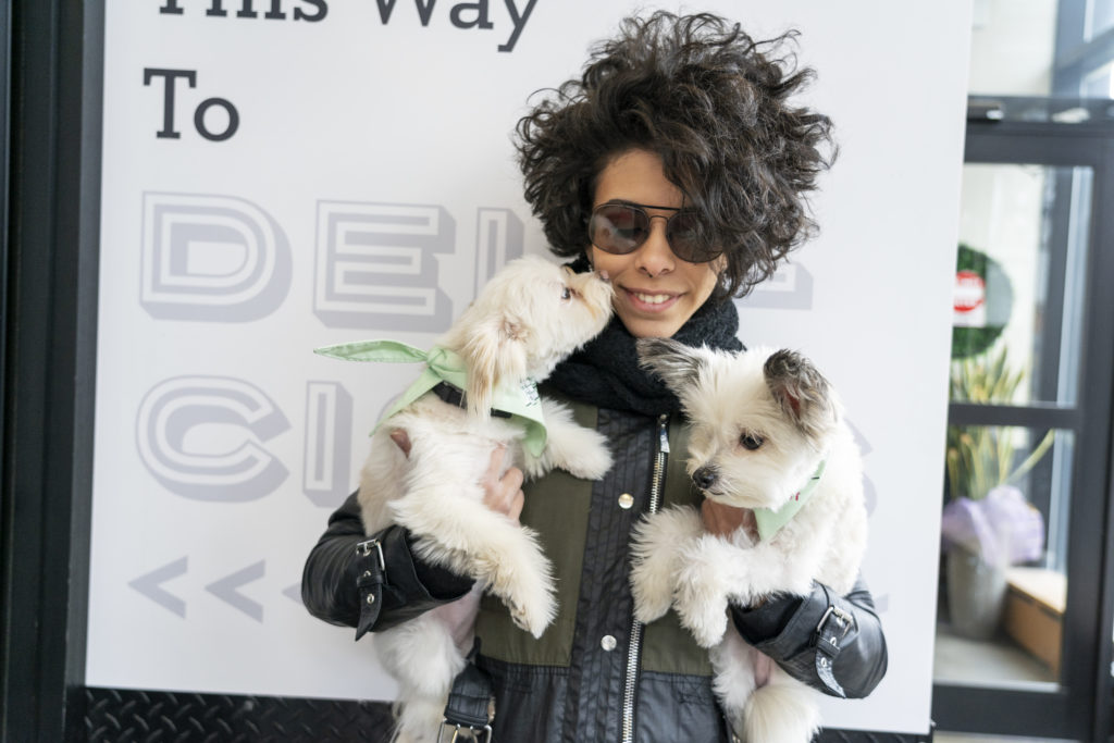 Kay Prieto holds her dogs, Coconut, left, and Katie outside a Brooklyn market. 