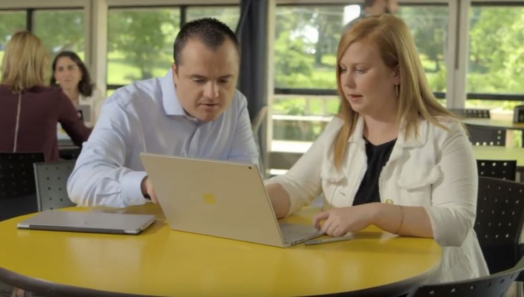 Bobby Berry and Beth Rogers look at a laptop. 