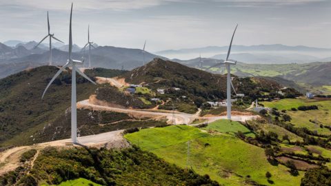landscape of a wind farm in rolling green hills