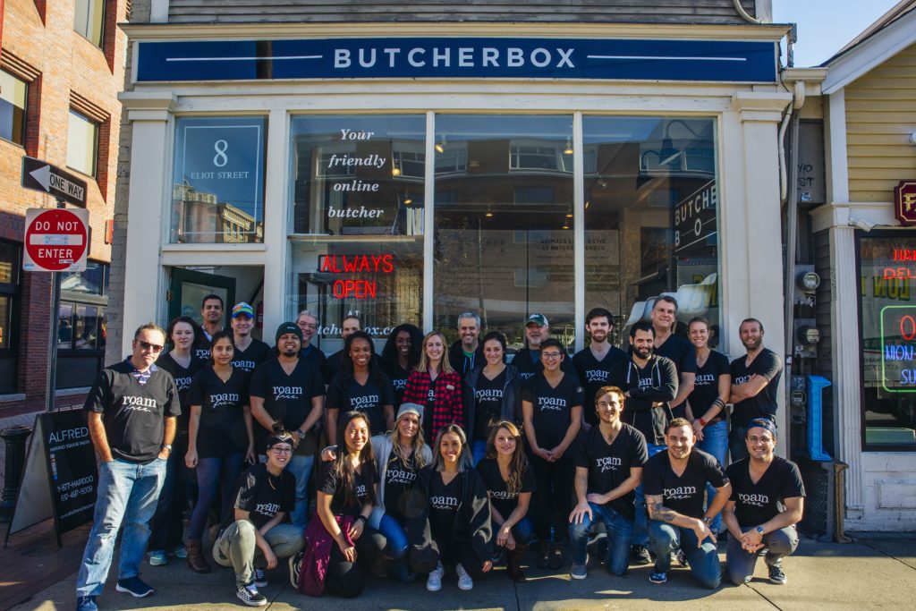 Image of ButcherBox employees posing on the street in front of the company's headquarters in Cambridge, Massachusetts.