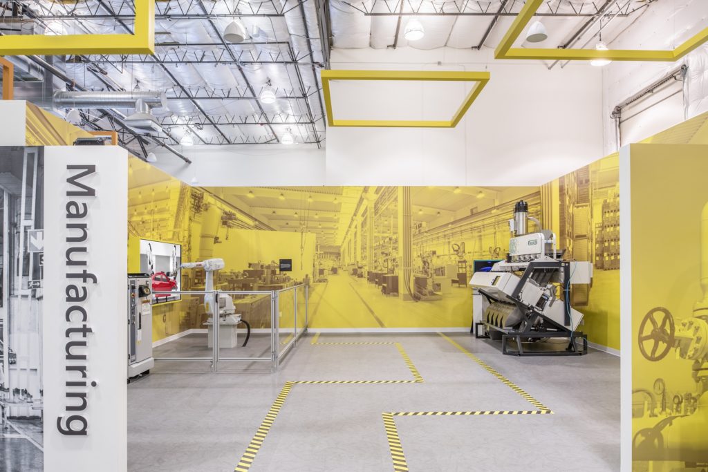 An optical sorter from Bühler and a compact industrial robot from ABB in the manufacturing area of Microsoft's new Industry Experience Center.
