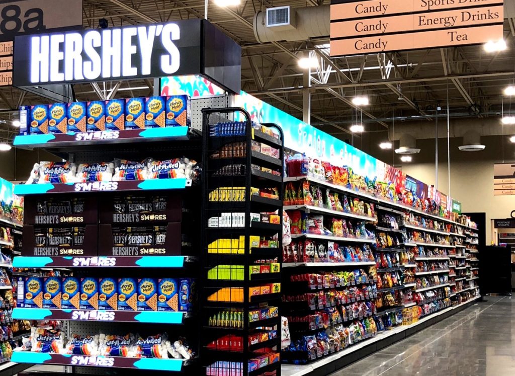 A grocery aisle featuring a Hershey's display.