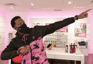 A T-Mobile retail employee doing the Usain Bolt lightning bolt gesture