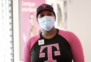 A T-Mobile retail manager wearing a mask