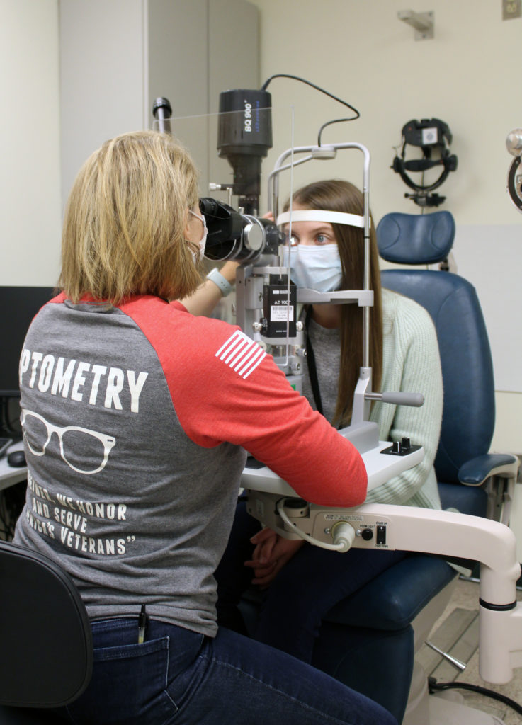 A veteran undergoes an eye exam at a VA medical facility.