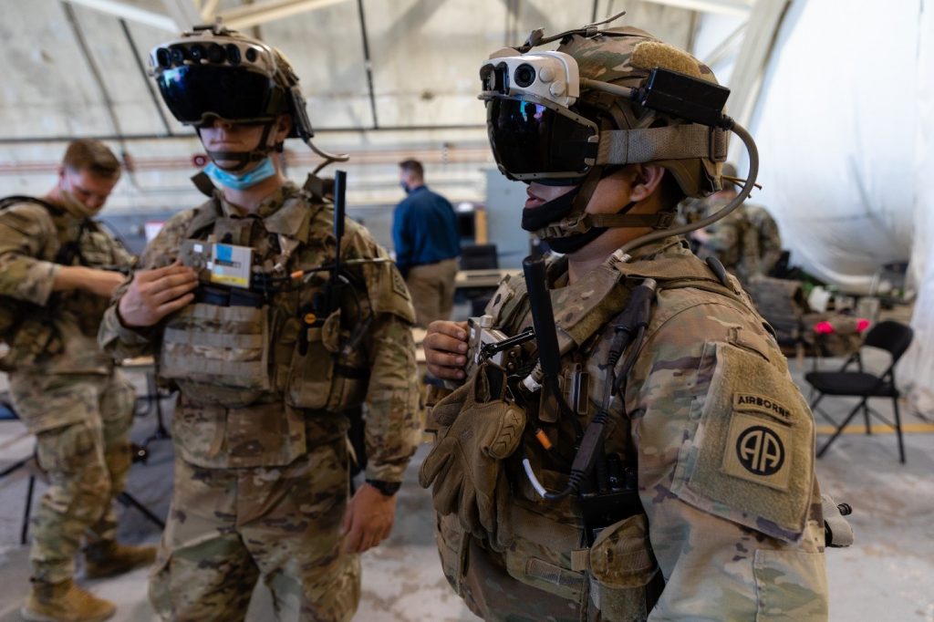 Photo of two soliders wearing mixed-reality headsets.