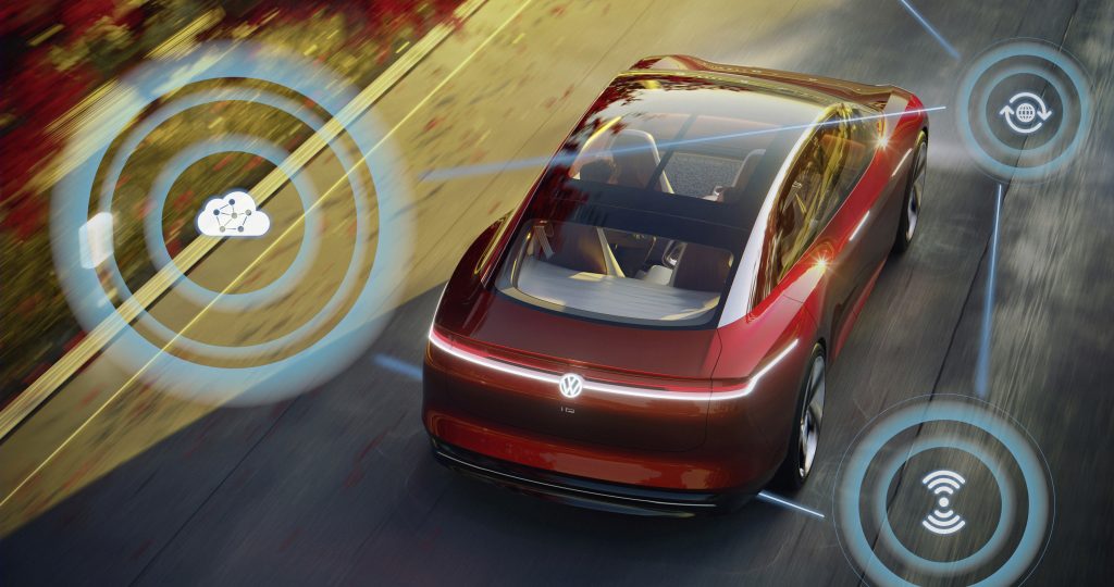 Aerial photo of red Volkswagen car with graphics superimposed on image depicting autonomous driving features.