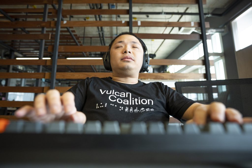 Vulcan Coalition software engineer Punnaphoj Aeuepalisa works on a keyboard